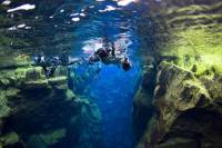 Snorkelling at Silfra in Crystal Clear Water between Two Tectonic Plates